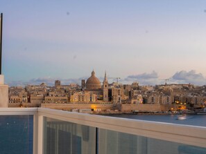 A cityscape with a prominent dome and spires, viewed from a balcony overlooking a body of water. - Spacious Private Apartment With Sunny Balcony (Sliema)
