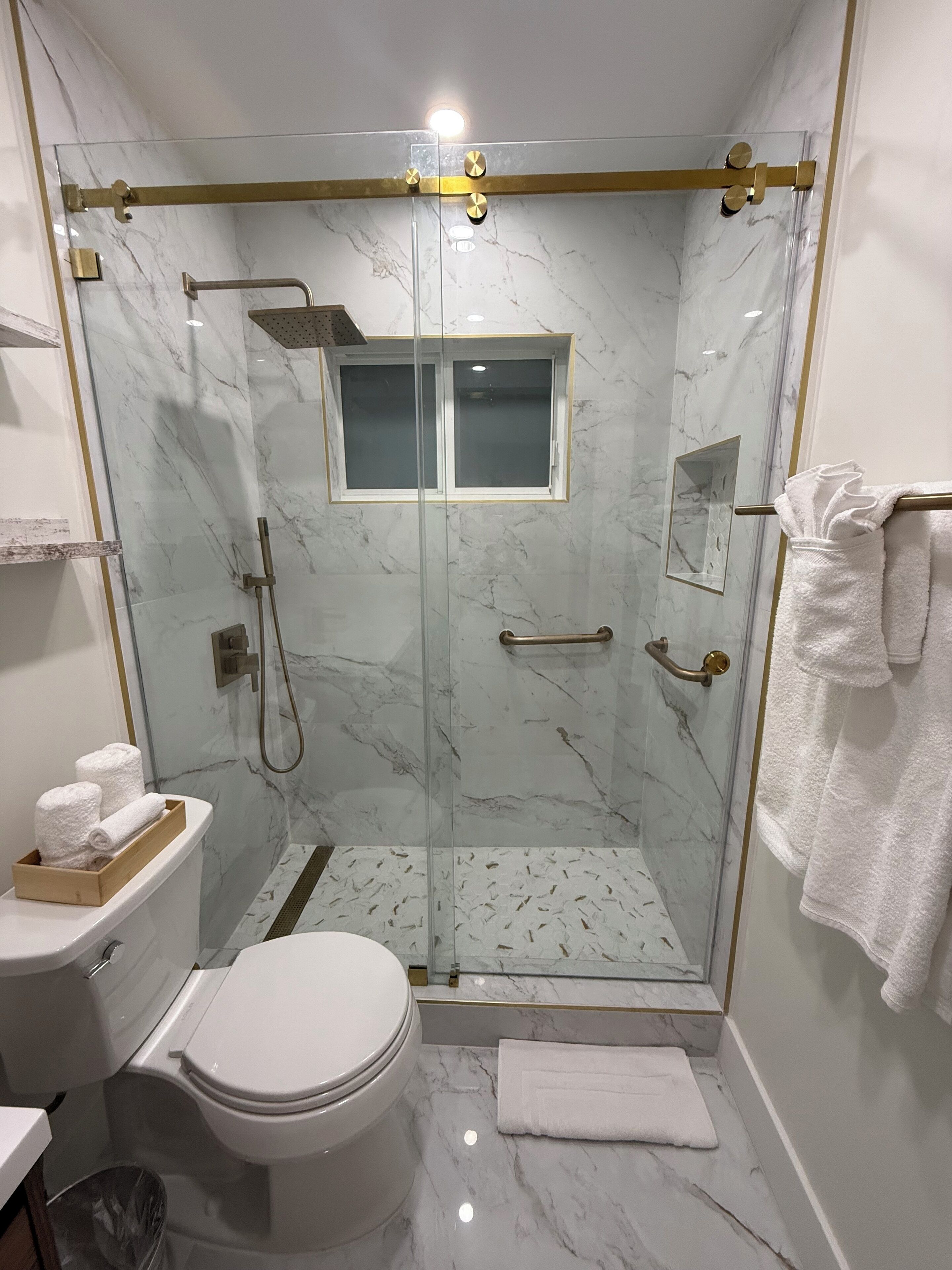 Shower, hair dryer, towels, toilet paper