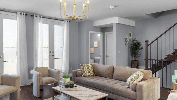 A living room with a sofa, armchairs, a coffee table, and a chandelier. - Luxury Townhome w/ Private Elevator (Newmarket)