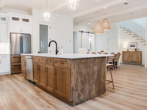 A modern kitchen with a central island, stainless steel appliances, and a wooden cabinet. - 🦩Book Me Baby! Daydream Believer in Seagrove Beach 🦩 (Seagrove Beach)