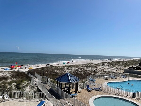 A beach resort with a pool area, beach umbrellas, and a gazebo. - Cozy 1- Studio Style condo, unit 103 in lovely Orange Beach, AL with AC. (Orange Beach)