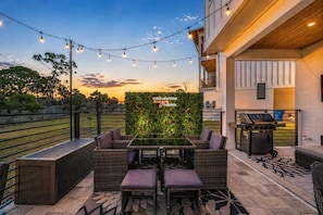 Outdoor dining - 5BR, 4.5BA Coastal Escape w/ Pool, Elevator, Near Beach & Attractions (Panama City Beach)