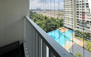 A balcony with a view of a swimming pool and surrounding buildings. - Residensi Suasana Damai by Airhost (Sungai Buloh)