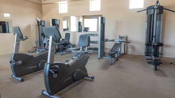 A gym with cardio machines, free weights, and dumbbells. - Cozy 2-Bedroom Condo with Mountain View, Hot tub and Heated Pools (Mesa)