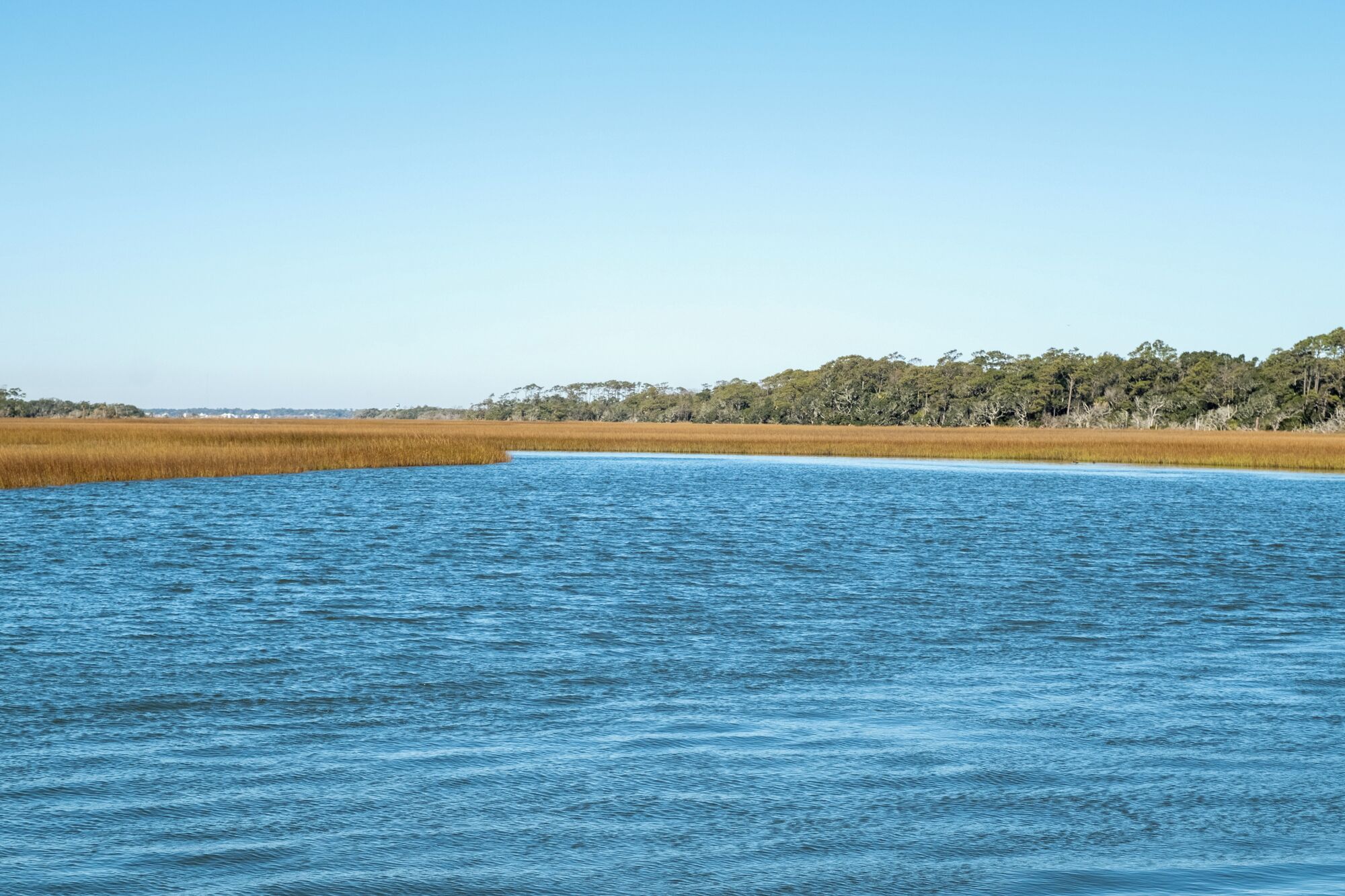 A calm body of water with a clear sky.