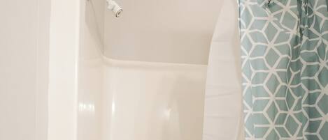 Un baño con bañera, ducha y retrete.