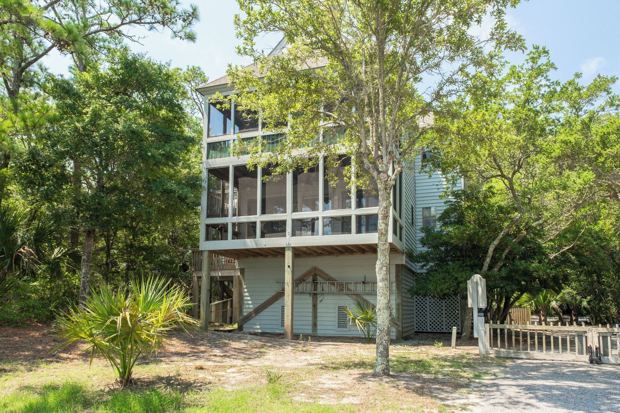 A two-story building with large windows and a wooden deck.