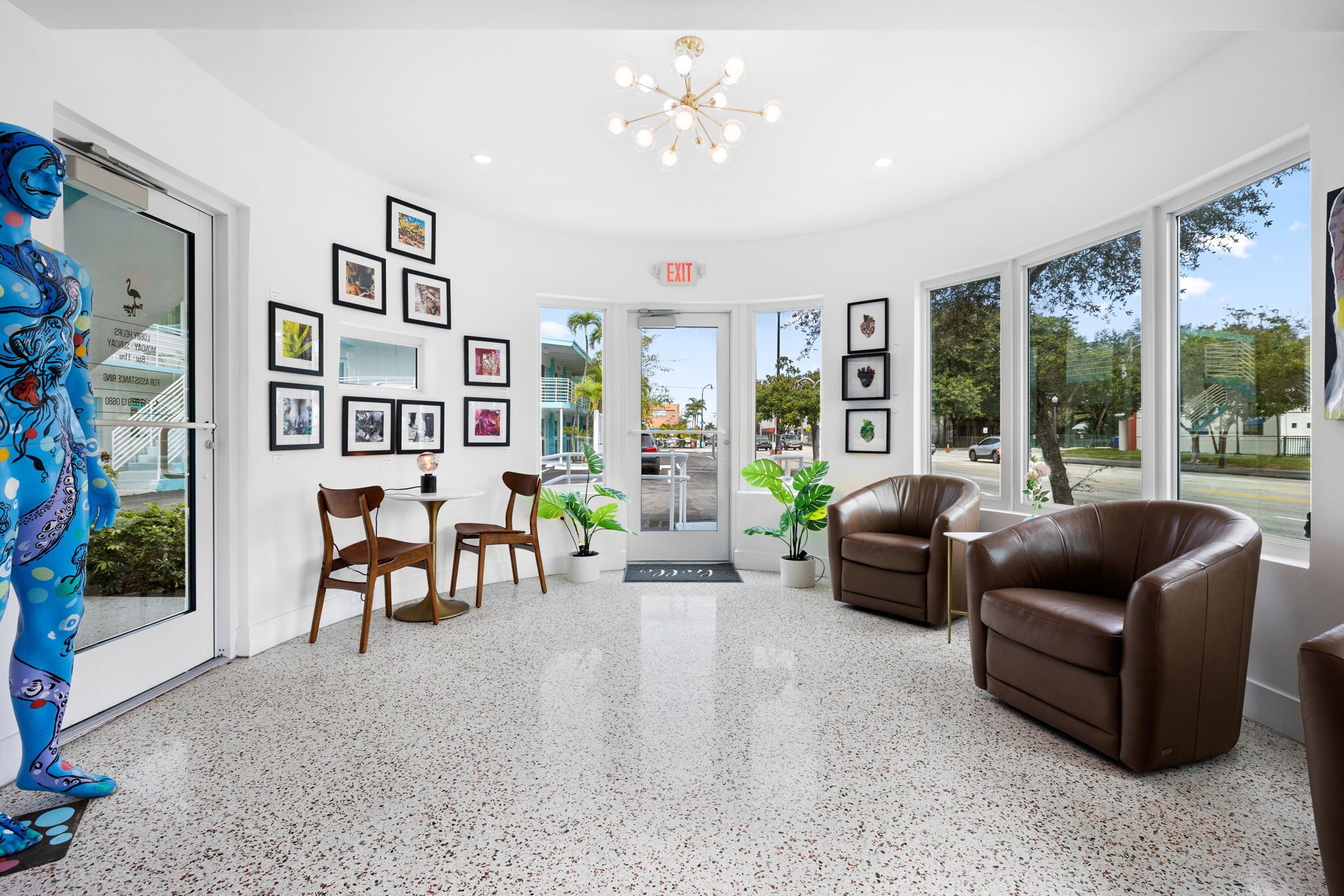 A modern lobby with a polished floor, framed artwork on the walls, and comfortable seating.