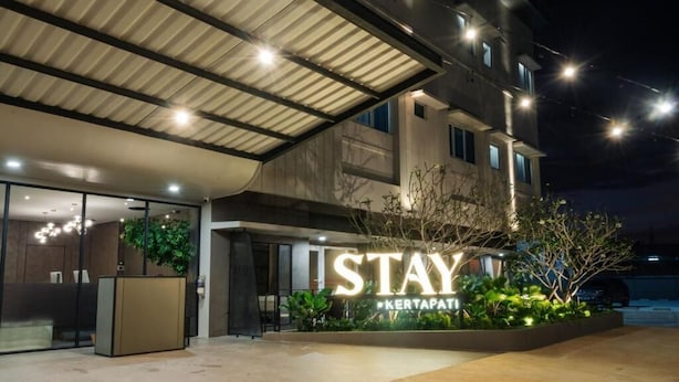 A hotel entrance with a large illuminated sign reading "STAY KERTAPATI" and a reception desk. - STAY KERTAPATI HOTEL (Palembang)