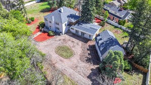An aerial view of a large house with a spacious driveway, surrounded by trees and a well-maintained lawn. - Broadmoor Guest Mother-in-Law Suite (Colorado Springs)