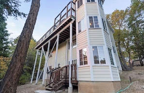 A multi-level wooden house with a balcony, surrounded by trees. - Private hot tub, Gorgeous views, Just minutes from the ski resorts & Lake (Big Bear Lake)