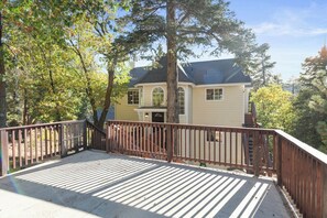 A two-story house with a covered deck and a staircase leading to the entrance. - Private hot tub, Gorgeous views, Just minutes from the ski resorts & Lake (Big Bear Lake)