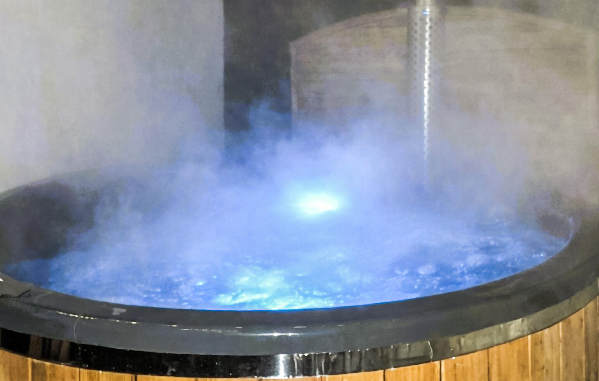 Une source thermale où de la vapeur s'élève à la surface de l'eau.