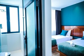 A hotel room with two beds, a window, and a door. - The Journey Hotel Penang (George Town)