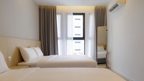 A hotel room with two beds, a window with curtains, a mirror, and an air conditioning unit. - The Journey Hotel Penang (George Town)
