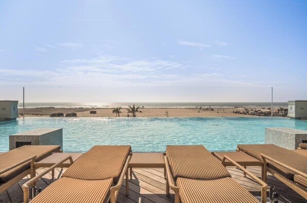 A heated pool - Luxury Beachfront 1BR Condo with Infinity Pool & Private Veranda (Wildwood)