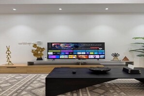 Luxury Apartment | Living area | 65-inch Smart TV with digital channels - Apartment in Al Muzn Residence Air Port (Seeb)