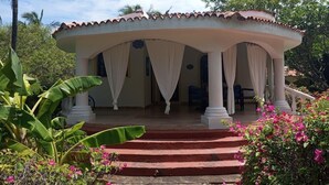 A covered outdoor area with a curved roof, white columns, and a staircase leading up to it. - 2 Livu Villas Watamu (Watamu)