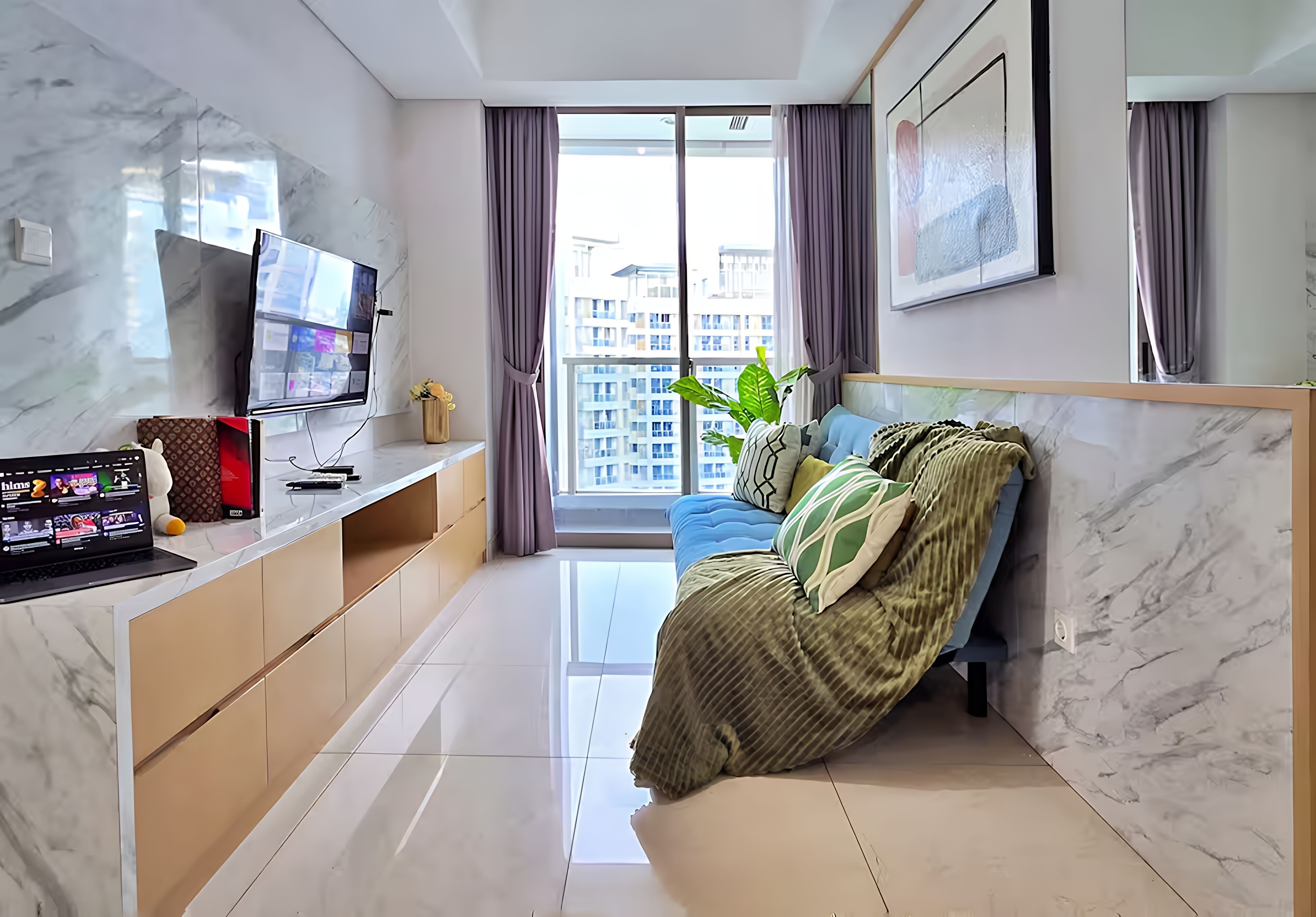 A modern living room with a large TV, a sofa, a coffee table, and a window with curtains.