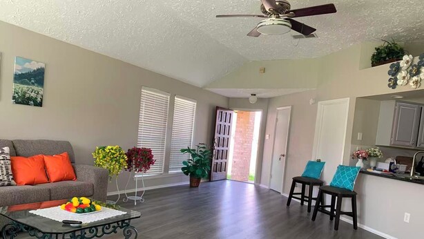 A living room with a sofa, coffee table, and potted plants. - Peaceful Retreat  Near NASA & Kemah 3BR/2BA (Houston)