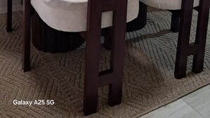 A dining area with a round table and four chairs, a small potted plant on a shelf, and a textured rug on the floor. - 2-bedroom apartment with Lake views and a heated pool in Nakuru Town (Nakuru)