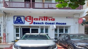 A two-story building with a sign for 'Ejanta Beach Guest House'. - Ajantha Guest House (Puducherry)