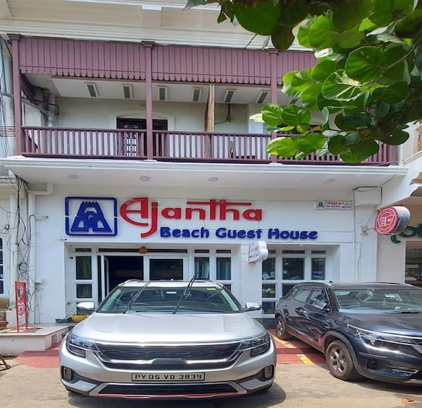 A two-story building with a sign for 'Ejanta Beach Guest House'.