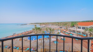 A resort with a pool area, beach, and ocean view. - Geumneung inn (Jeju City)
