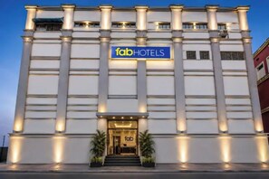 A building with a sign reading 'fabHOTELS' at the entrance, featuring a symmetrical facade with evenly spaced windows and a central entrance. - Fabhotel Demattrie Budget (Kolkata)
