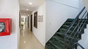 Un pasillo con una escalera que sube a una plataforma.