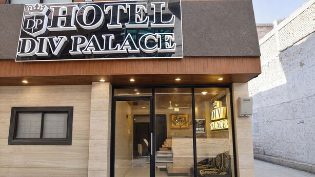 A hotel entrance with a sign reading 'HOTEL DIV PALACE,' a glass door, and a staircase leading inside. - Fabhotel Div Palace (Indore)