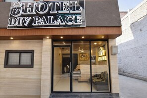 A hotel entrance with a sign reading 'HOTEL DIV PALACE,' a glass door, and a staircase leading inside. - Fabhotel Div Palace (Indore)