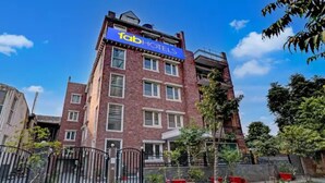 A multi-story building with a sign reading "Fab Hotels". - Fabhotel Pantao Stay (Noida)