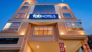 A building with a sign reading 'fabHOTELS' and another sign for 'BLOK CAFE HOUSE.' - Fabhotel Cozy Stay (Noida)