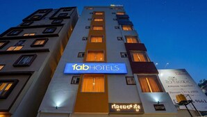 A multi-story building with a prominent 'fab hotels' sign, indicating a hotel property. - Fabhotel Global Stay (Bangalore)