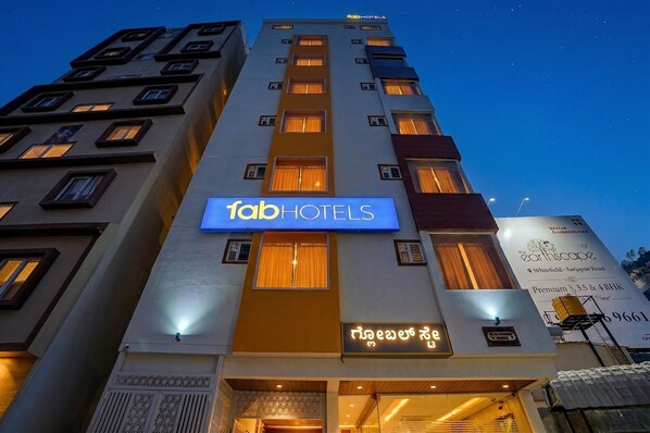 A multi-story building with a prominent 'fab hotels' sign, indicating a hotel property. - FabHotel Global Stay - Sarjapur (Bangalore)