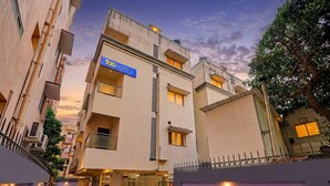 A multi-story building with a sign for 'fabHOTELS' on the facade. - Fabhotel Neha (Chennai)