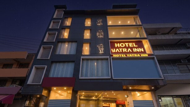 A multi-story hotel with a prominent 'HOTEL YATRA INN' sign, large windows, and a modern architectural design. - Fabhotel Yatri Inn (Noida)