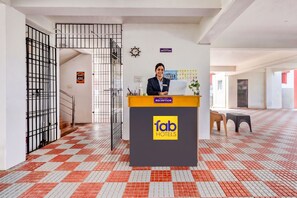 A reception desk with a sign for 'fab hotels' and a clock on the wall. - Fabhotel Dp Residency (Chennai)
