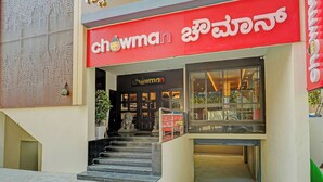 A restaurant entrance with a red sign, a staircase leading inside, and a large window display. - Fabhotel Global Stay Rajajinagar (Bangalore)
