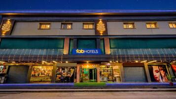 A hotel with a prominent sign, multiple windows, and a storefront with visible merchandise.