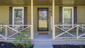 A porch with two chairs, a door, and a small window. - 6 mi to Stone Mountain Park – Cozy Family Retreat (Snellville)