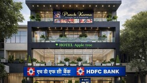 A modern building with a sign for Punch Karma Ayurvedic Spa & Pantharma, HOTEL Apple tree, and HDFC Bank.