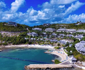 A coastal resort with multiple buildings, a beach, and a clear blue sky. - Breathtaking Views Private 1 Bed Villa (Freetown)
