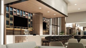 A modern bar area with a long counter, multiple seating options, and a large flat-screen TV. - Fairfield Inn & Suites San Luis Potosi Los Lagos (San Luis Potosi)