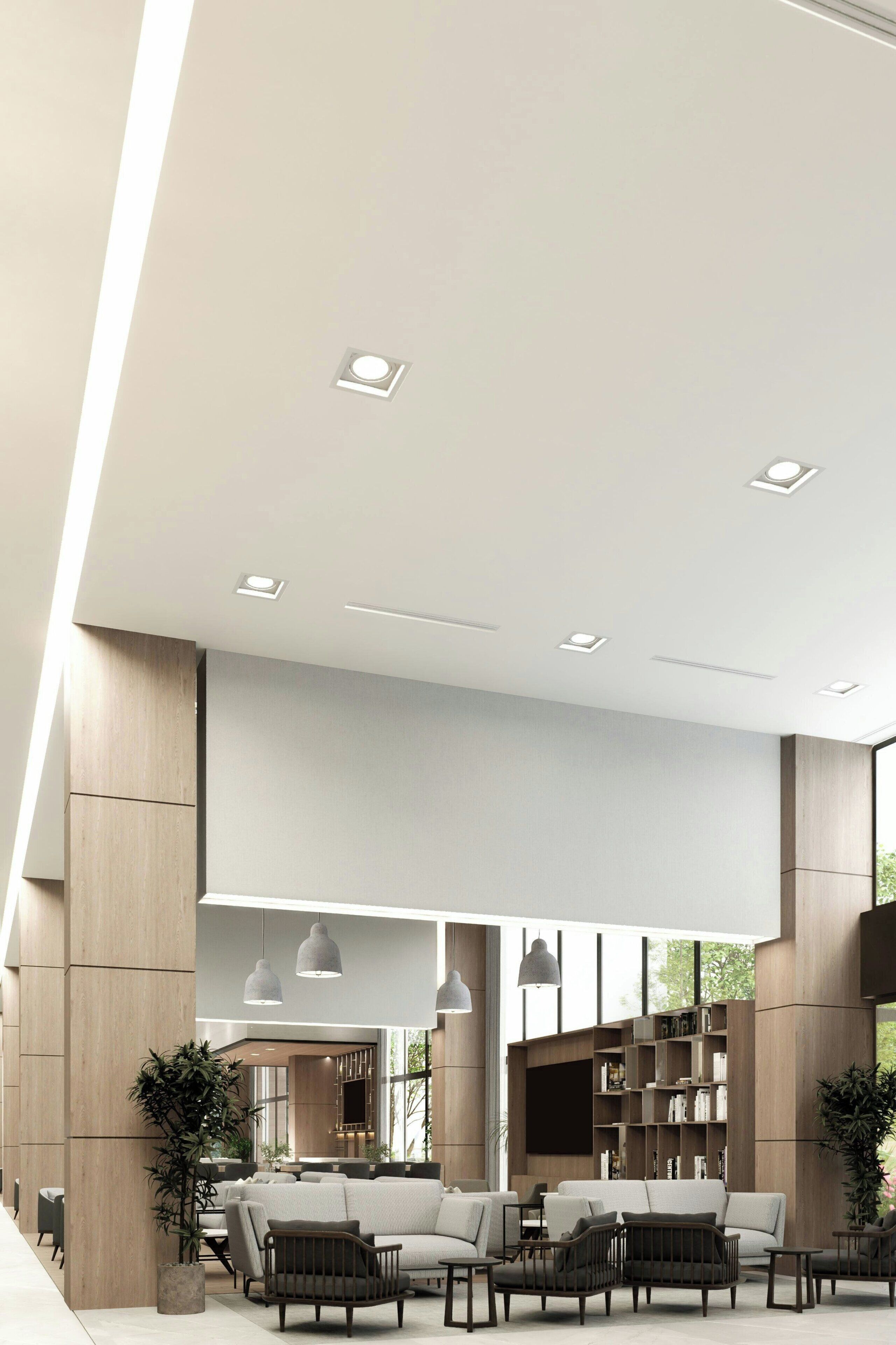 A modern interior with a sofa set, pendant lights, and a bookshelf.