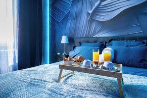 A bedroom with a bed, bedside table, and a tray with breakfast items. - Luxuria Love Room Avignon (Avignon)