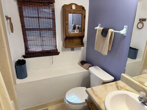 A bathroom with a toilet, sink, mirror, towel rack, and window with blinds. - 3-bedroom bungalow in fantastic Riverdale with cool AC , 10 minutes from airport (Riverdale)