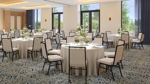 A conference room with round tables, chairs, and floral centerpieces. - The Brandywine, Radnor, a Tribute Portfolio Hotel (Wayne)