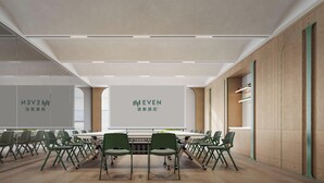A conference room with a long table, chairs, and presentation screens.